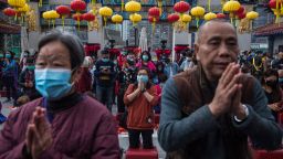 TOPSHOT - People wear masks as they pray at Wong Tai Sin temple on the first day of the Lunar New Year of the Rat in Hong Kong on January 25, 2020, as a preventative measure following a coronavirus outbreak which began in the Chinese city of Wuhan. - Hong Kong on January 25 declared a mystery virus outbreak as an "emergency" -- the city's highest warning tier -- as authorities ramped up measures aimed at reducing the risk of further infections spreading. (Photo by DALE DE LA REY / AFP) (Photo by DALE DE LA REY/AFP via Getty Images)