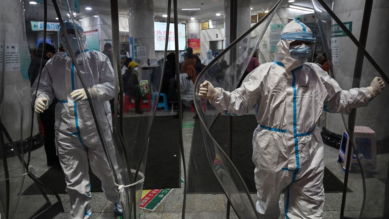 TOPSHOT - Medical staff members wearing protective clothing to help stop the spread of a deadly virus which began in the city, walk at the Wuhan Red Cross Hospital in Wuhan on January 25, 2020. - The Chinese army deployed medical specialists on January 25 to the epicentre of a spiralling viral outbreak that has killed 41 people and spread around the world, as millions spent their normally festive Lunar New Year holiday under lockdown. (Photo by Hector RETAMAL / AFP) (Photo by HECTOR RETAMAL/AFP via Getty Images)