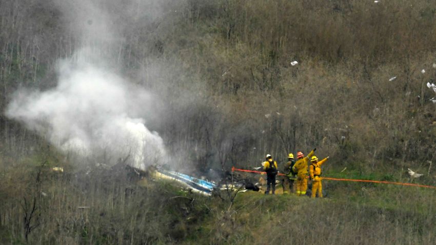 Firefighters work the scene of a helicopter crash where former NBA star Kobe Bryant died, Sunday, Jan. 26, 2020, in Calabasas, Calif. (AP Photo/Mark J. Terrill)