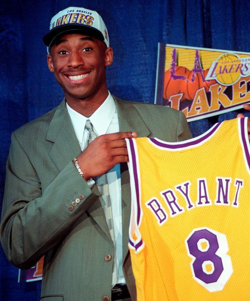 Bryant jokes with the media as he holds his Los Angeles Lakers jersey at a news conference in Inglewood, California, in 1996.