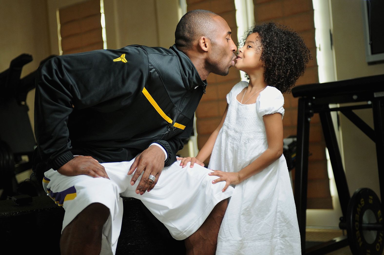 Bryant kisses his daughter Natalia during a 2008 photo session at his home in Newport Beach, California.