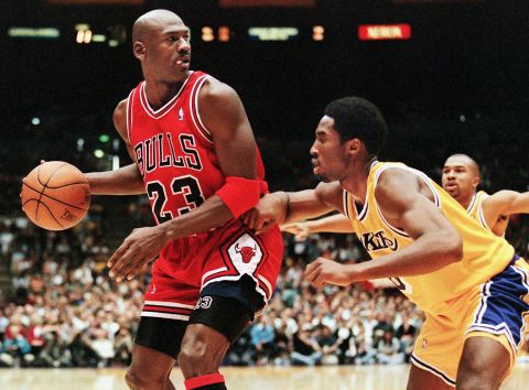 Michael Jordan of the Chicago Bulls eyes the basket as he is guarded by Bryant during a 1998 game in Los Angeles.