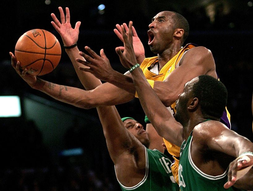 Bryant goes up for a shot between the Boston Celtics' Paul Pierce, left, and Al Jefferson during a 2006 game in Los Angeles.