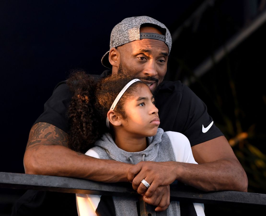 Kobe Bryant and daughter Gianna watch during Day 2 of the Phillips 66 National Swimming Championships at the Woollett Aquatics Center on July 26, 2018 in Irvine, California.