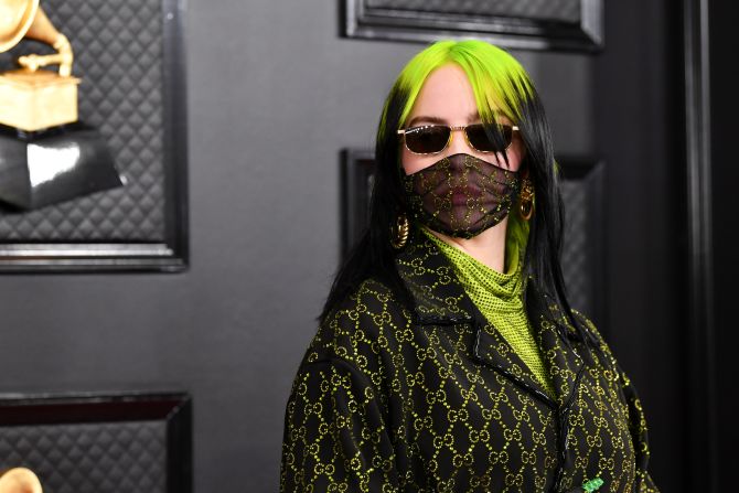 Billie Eilish wore a lime green and black Gucci suit with matching hair and accessories. 