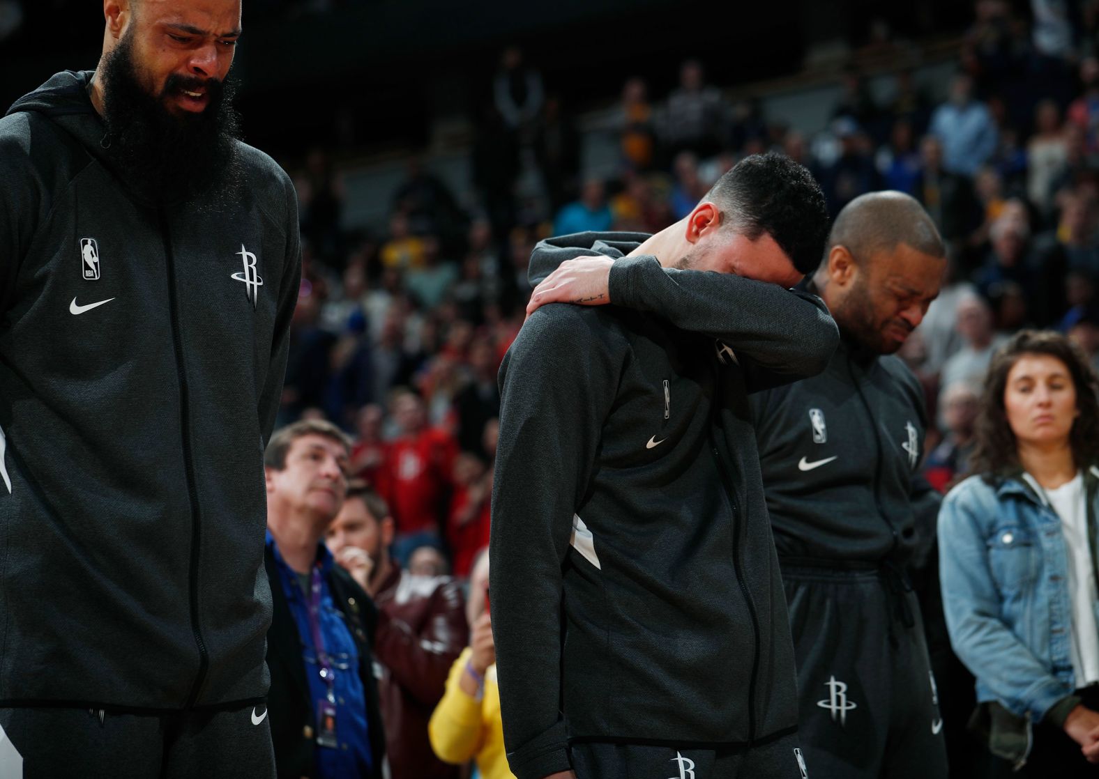 From left, Houston Rockets players Tyson Chandler, Austin Rivers and P.J. Tucker react during a tribute to Kobe Bryant before their game against the Denver Nuggets on Sunday, January 26.