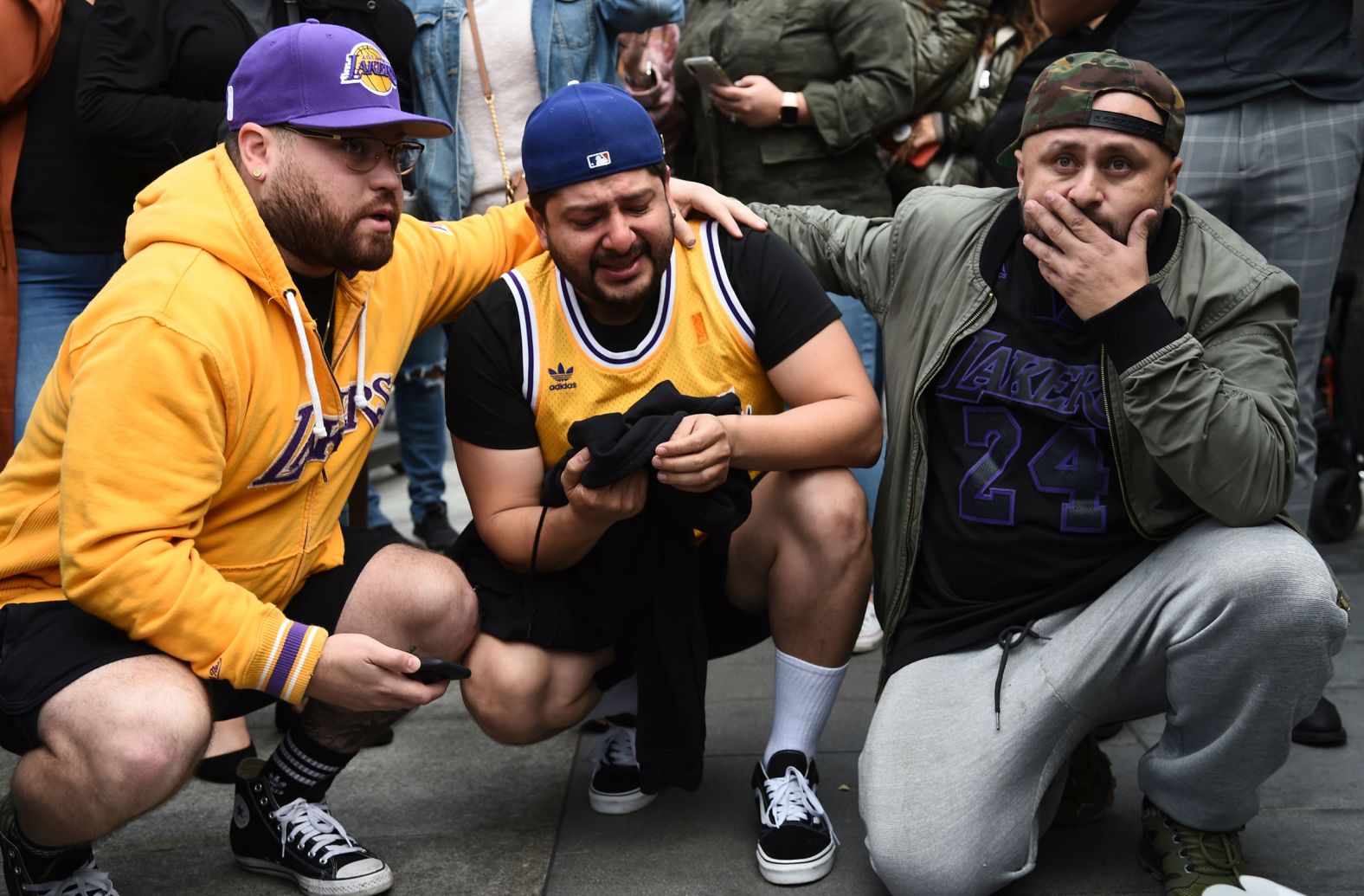 From left, Alex Fultz, Eddy Rivas and Rene Alfaro react to Bryant's death on Sunday outside of the Staples Center.
