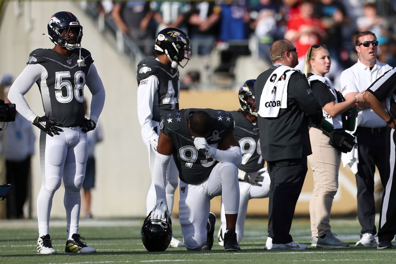 AFC defensive end Calais Campbell kneels as he and his teammates react to the announcement of Bryant's death Sunday in the second quarter of the 2020 Pro Bowl on Sunday in Orlando.