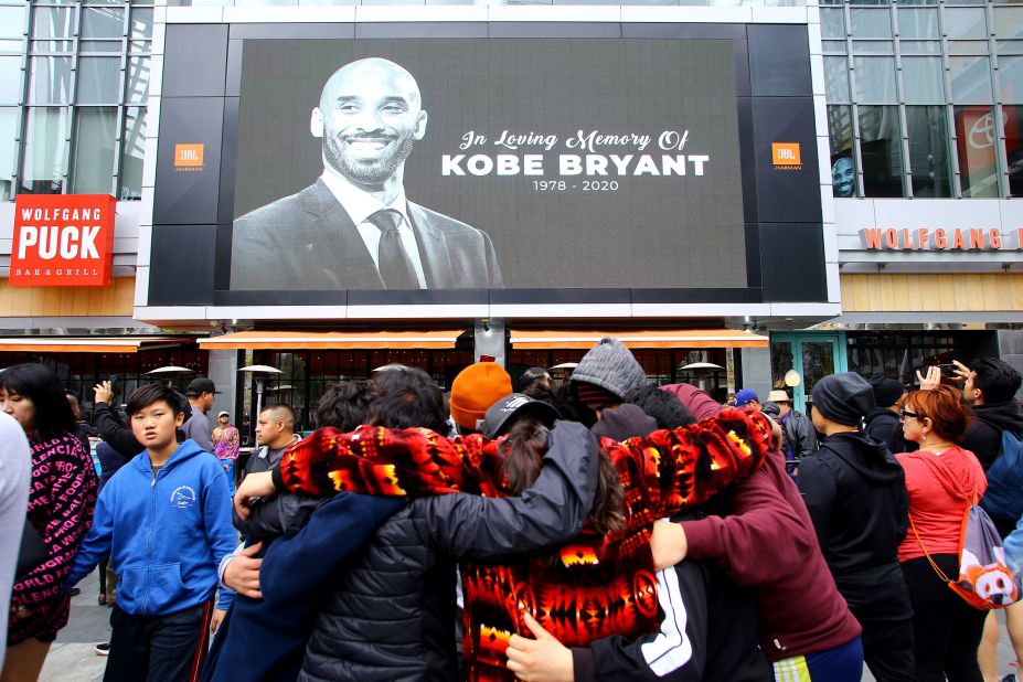 Fans mourn in front of Bryant's image across from Staples Center on Sunday.
