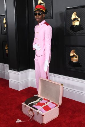 Tyler, the Creator accessorized his bellhop-inspired outfit with a piece of luggage.