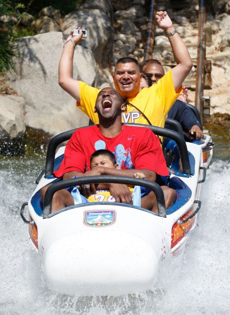 Bryant rides the Matterhorn Bobsleds with Jonathan Guerrero, 4, and his father, David Guerrero of Pomona, California, at Disneyland in Anaheim, California, in 2009. The Guerreros were among thousands of Lakers fans who turned out for a special Disneyland parade honoring the Lakers' 15th World Championship.