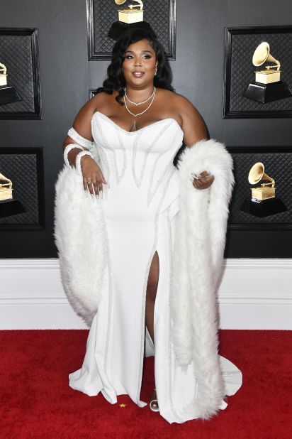 Lizzo arrives in a custom Versace dress embroidered with Swarovski crystals.