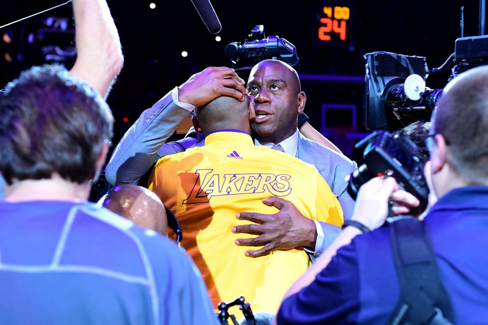 Magic Johnson hugs Bryant before the final game of his career in 2016.