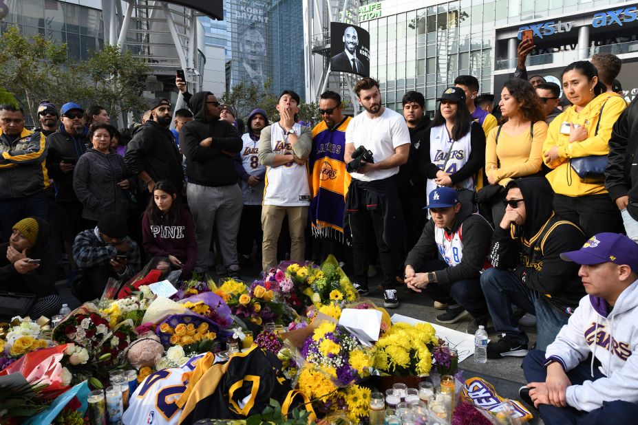 People gather at a memorial for Kobe Bryant near the Staples Center in Los Angeles on Sunday.