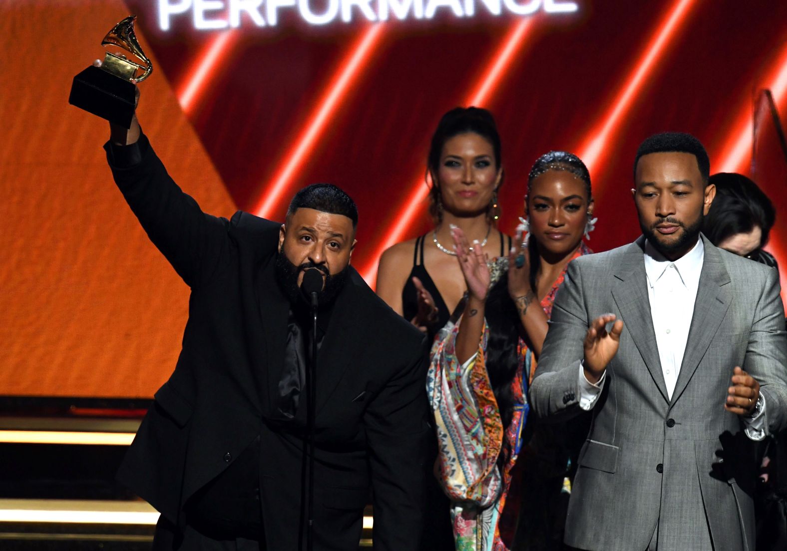 DJ Khaled, Samantha Smith, and John Legend accept the best rap/sung performance award for "Higher."
