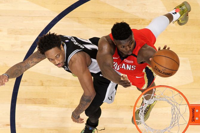 Zion Williamson of the New Orleans Pelicans makes a shot over DeMar DeRozan of the San Antonio Spurs on Wednesday, January 22, in New Orleans, Louisiana. <a href="index.php?page=&url=https%3A%2F%2Fwww.cnn.com%2F2020%2F01%2F23%2Fsport%2Fzion-williamson-nba-debut-spt-intl%2Findex.html" target="_blank">Williamson made his NBA debut on Wednesday</a> at age 19 after a preseason injury and necessary surgery kept him out for the start of the season.