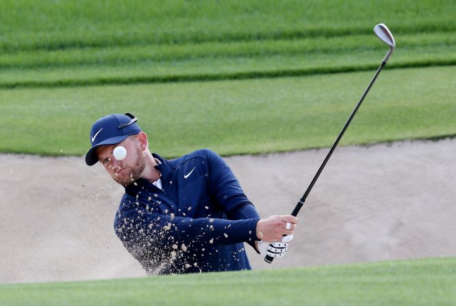 England's Tom Lewis chips the ball during the final round of the Dubai Desert Classic at Emirates Golf Club on Sunday, January 26.