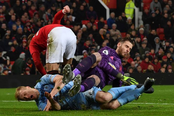 Manchester United's goalie David de Gea saves the ball from Burnley's defender Ben Mee during their match in Manchester on Wednesday, January 22.
