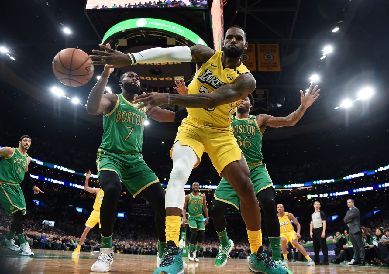 LeBron James of the Los Angeles Lakers passes the ball with pressure from Boston Celtics' Jaylen Brown during a game at TD Garden in Boston, Massachusetts, on Monday, January 20. The Celtics won 139-107.