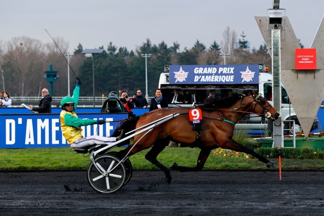 Swedish driver Bjorn Goop with his horse Face Time Bourbon waves across the finish line during the 100th Grand Prix d'Amerique in Paris on Sunday, January 26. It was the 19th victory in just 22 career starts for Face Time Bourbon.