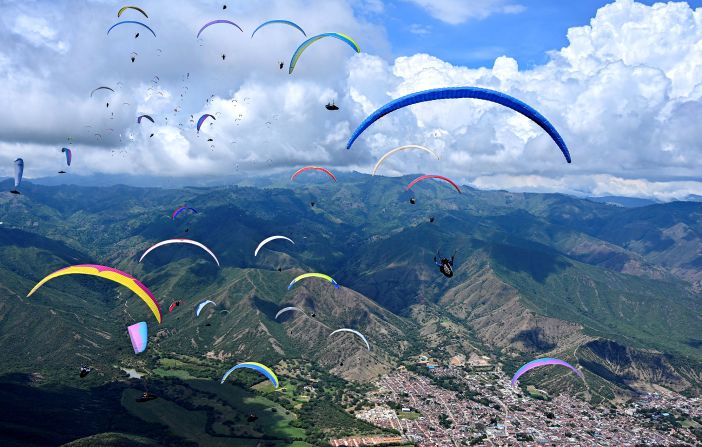 Paragliders fly over the mountains in the Valle del Cauca, Colombia, during the British Winter Open on Saturday, January 25.