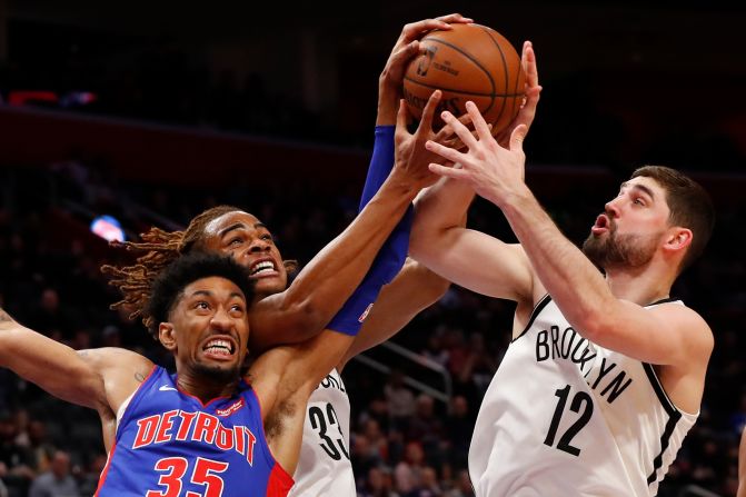 Detroit Pistons' Christian Wood, Brooklyn Nets' Nicolas Claxton and Joe Harris battle for a rebound during a game in Detroit on Saturday, January 25. The Nets won 121-111. 