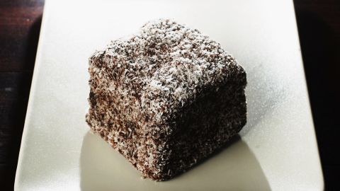 A lamington, the national cake of Australia, is a sponge cake dipped in chocolate and coated in desiccated coconut.