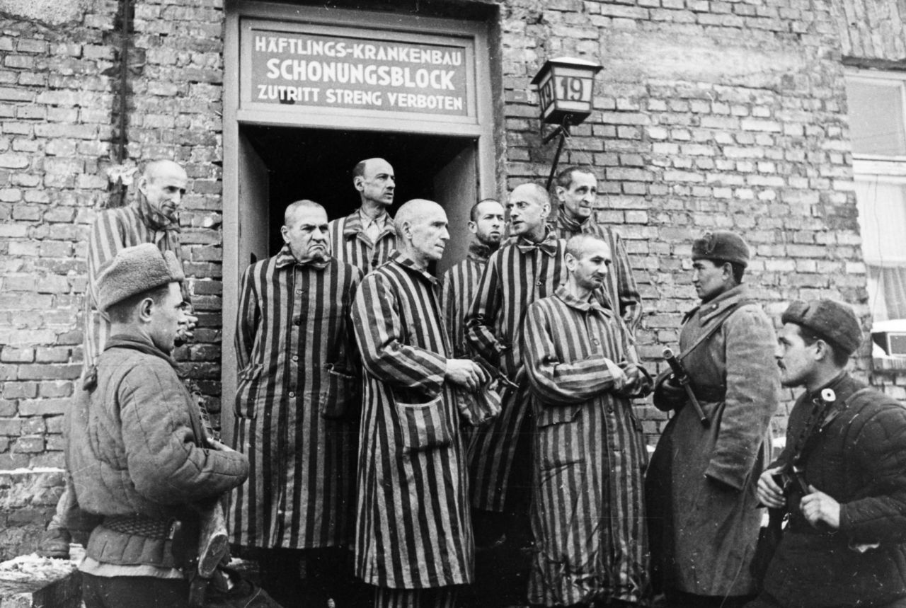 Soviet soldiers are seen with liberated prisoners. 