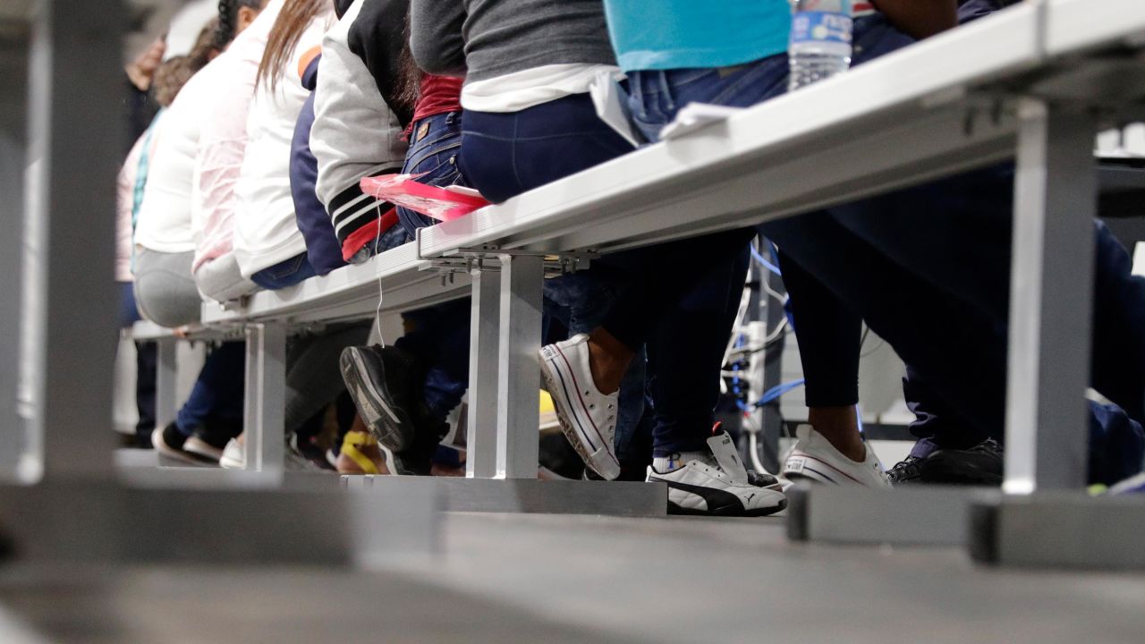 Migrants who are applying for asylum in the United States go through a processing area at a tent courtroom, Tuesday, Sept. 17, 2019, in Laredo, Texas.