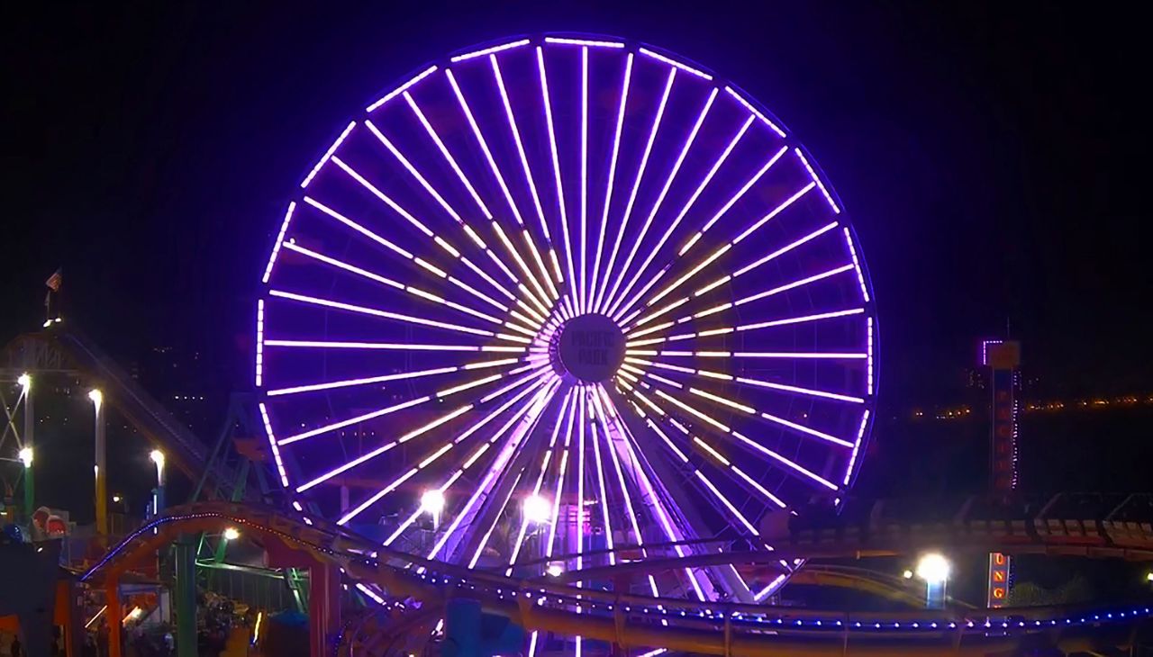 The Pacific Park Ferris wheel at the Santa Monica Pier is lit up purple and gold with Kobe Bryant's number 24 in Los Angeles on January 26.