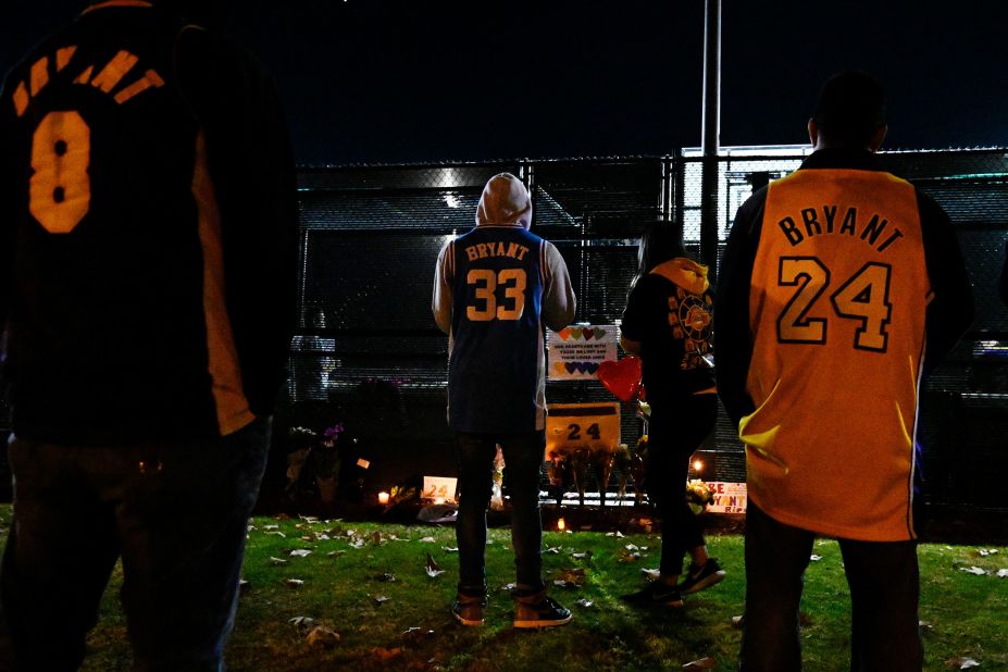 People gather near a small memorial outside of a basketball court in Calabasas, California, on January 26.