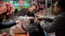 This picture shows a butcher selling yak meat at a market in Beijing on January 15, 2020. 