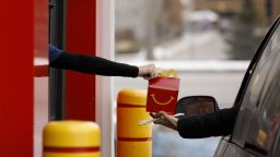A customer receives an order from a drive-thru window at a McDonald's Corp. restaurant in London, Ontario, Canada, on Wednesday, Jan. 8, 2020. Fifty-two McDonald's locations in southwestern Ontario will now serve the "P.L.T." sandwich -- plant, lettuce and tomato that feature Beyond Meats pea-based patties-- for 12 weeks starting Jan. 14. Photographer: Cole Burton/Bloomberg via Getty Images