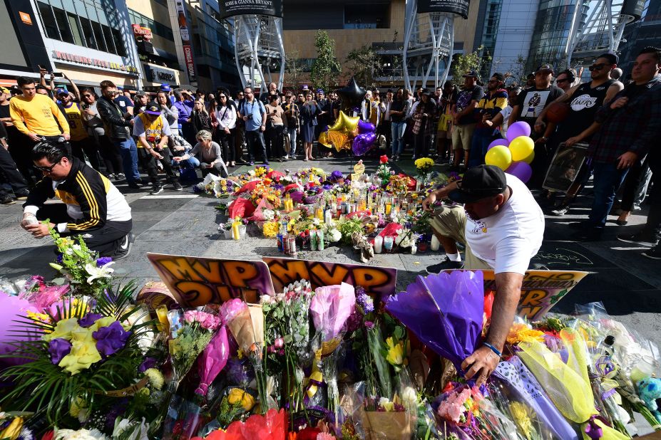 Fans place flowers at a makeshift memorial outside of the Staples Center in Los Angeles on January 27.