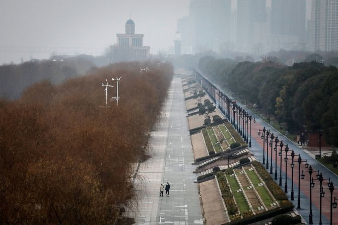 Two residents walk in an empty park in Wuhan on January 27, 2020. The city remained on lockdown for a fourth day.