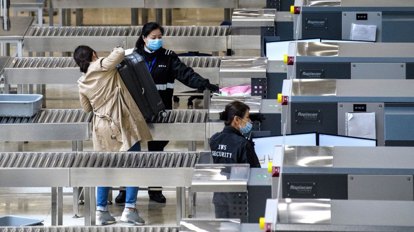Members of security wear facemasks inside the high-speed train station connecting Hong Kong to mainland China during a public holiday in celebration of the Lunar New Year in Hong Kong on January 28, 2020, as a preventative measure following a virus outbreak which began in the Chinese city of Wuhan. - China on January 28 urged its citizens to postpone travel abroad as it expanded unprecedented efforts to contain a viral outbreak that has killed 106 people and left other governments racing to pull their nationals from the contagion's epicentre.