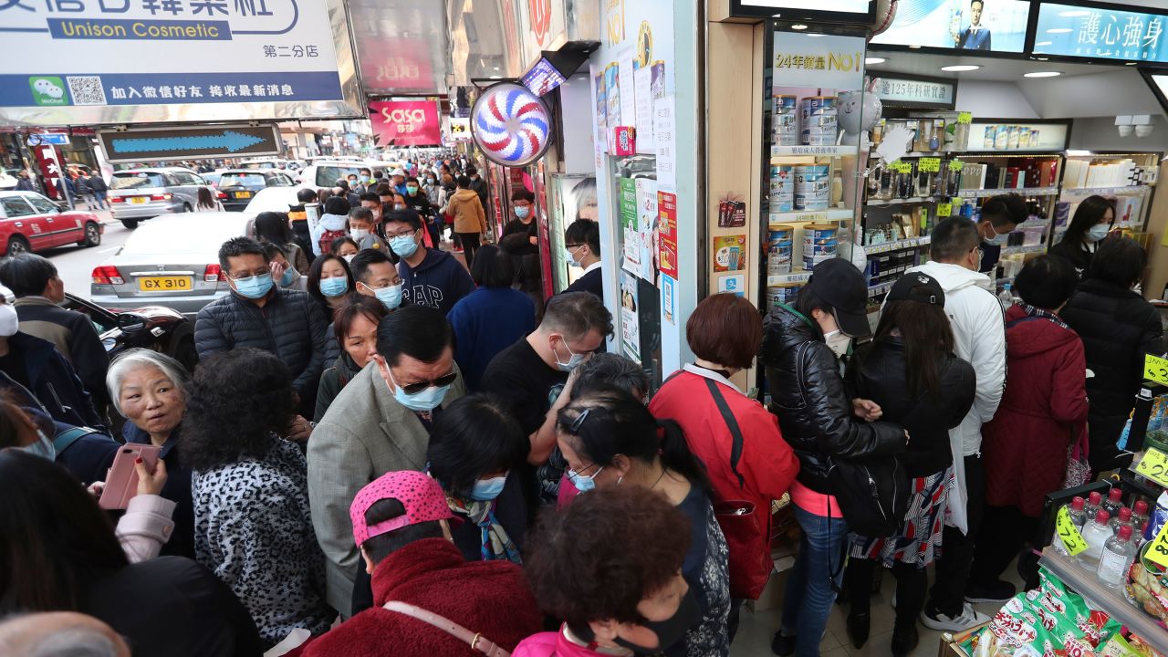 People queue for free face masks outside a cosmetics shop at Tsuen Wan in Hong Kong.