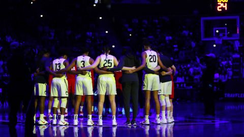 The UConn Huskies and Team USA huddle for a moment of silence in the Bryants' honor Monday. 