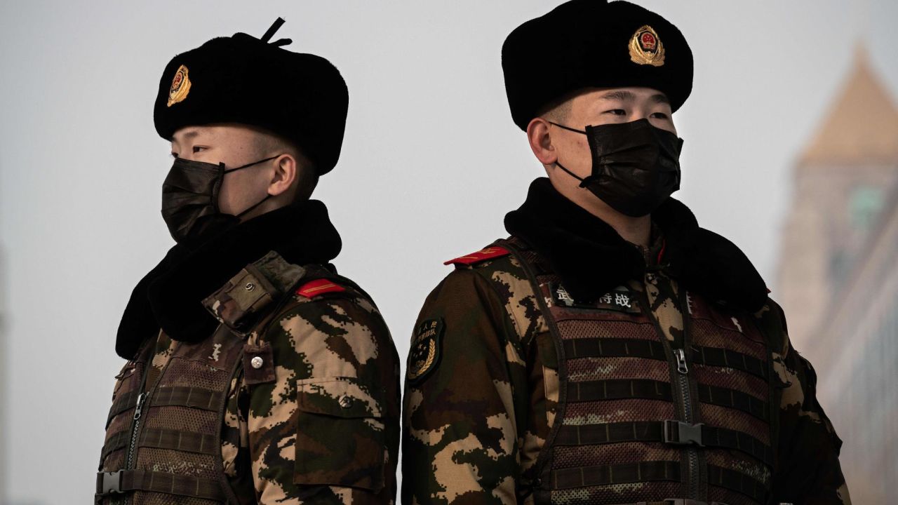 Paramilitary police officers wearing a protective mask to help stop the spread of a deadly virus which began in Wuhan, stand guard at the Beijing railway station in Beijing on January 27, 2020. - China on January 27 extended its biggest national holiday to buy time in the fight against a viral epidemic and neighbouring Mongolia closed its border, after the death toll spiked to 81 despite unprecedented quarantine measures. (Photo by NICOLAS ASFOURI / AFP) (Photo by NICOLAS ASFOURI/AFP via Getty Images)