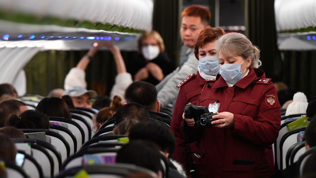 Workers at an airport in Novosibirsk, Russia, check the temperatures of passengers who arrived from Beijing on January 28.