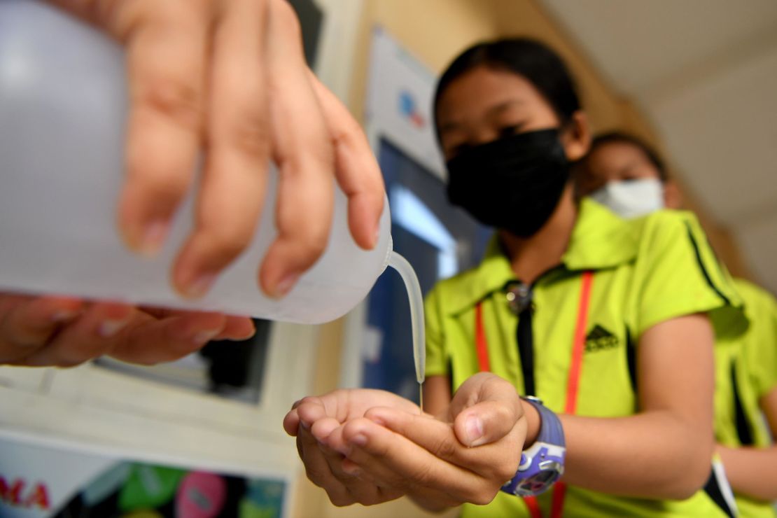 Students disinfect their hands with an alcohol solution before entering class at a school in Phnom Penh, Cambodia on January 28, 2020.