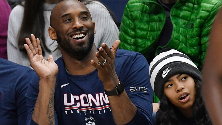 Kobe Bryant and his daughter Gianna watch the first half of an NCAA college basketball game between Connecticut and Houston, Saturday, March 2, 2019, in Storrs, Conn. (AP Photo/Jessica Hill)