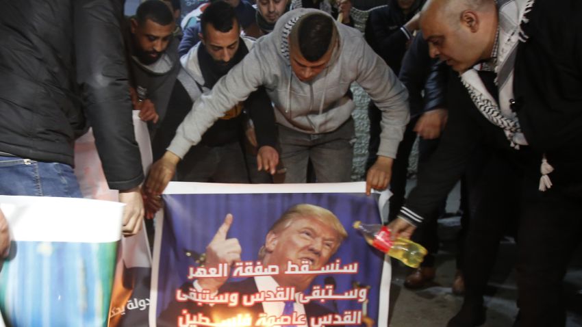 Palestinian demonstrators prepare to burn posters of US President Donald Trump during a protest against the US Middle East peace plan, in the Deheisheh refugee camp near the West Bank city of Bethlehem, on January 27, 2020. (Photo by Musa Al SHAER / AFP) (Photo by MUSA AL SHAER/AFP via Getty Images)
