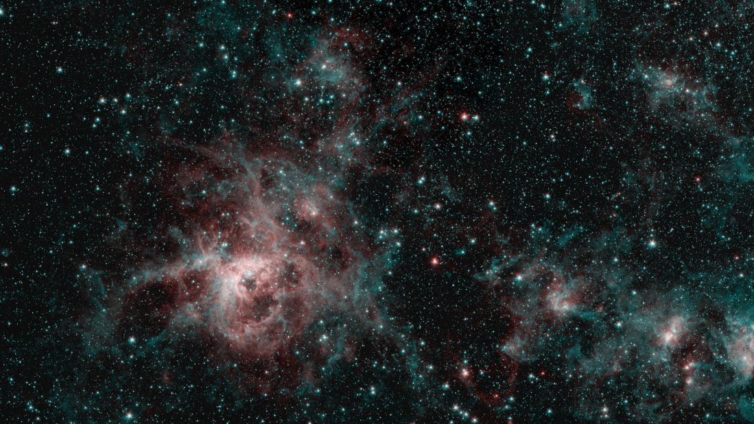 This Spitzer image shows the Tarantula Nebula in two wavelengths of infrared light. The red regions indicate the presence of particularly hot gas, while the blue regions are interstellar dust.