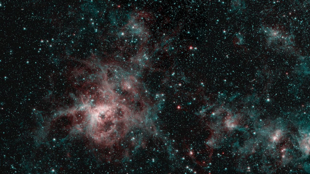 This Spitzer image shows the Tarantula Nebula in two wavelengths of infrared light. The red regions indicate the presence of particularly hot gas, while the blue regions are interstellar dust.
