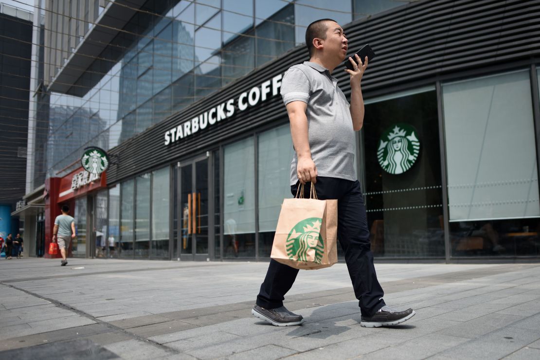 A man walks past a Starbucks coffee shop in Beijing in 2018.
