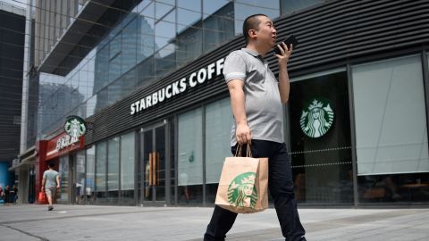 A man walks past a Starbucks coffee shop in Beijing in 2018.