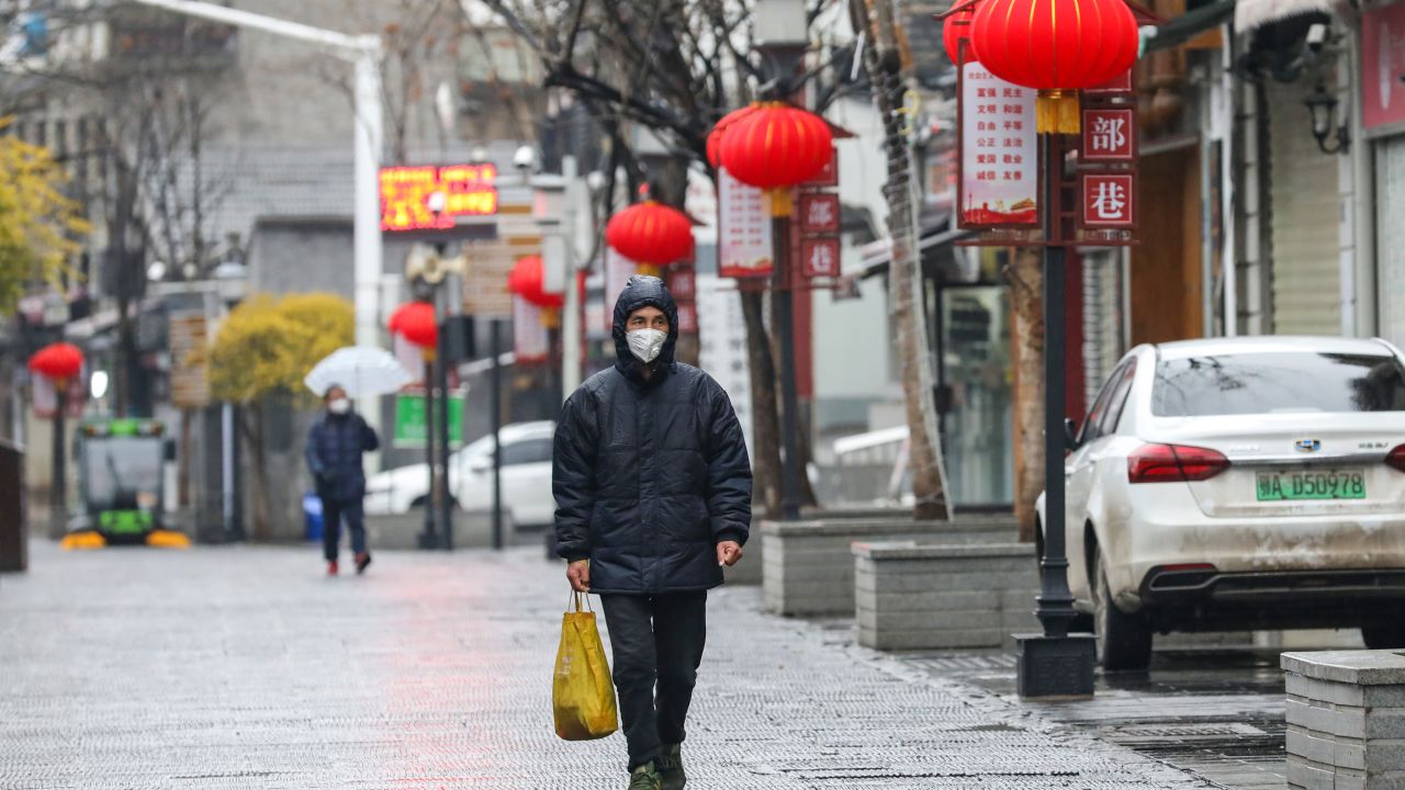 A masked man walks in an empty street in Wuhan on Lunar New Year's Day.