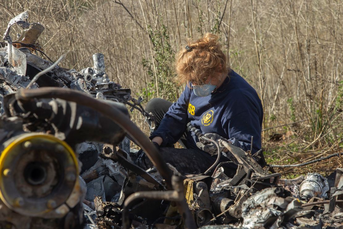 NTSB investigator Carol Horgan examines wreckage at the crash site as part of the NTSB's investigation.