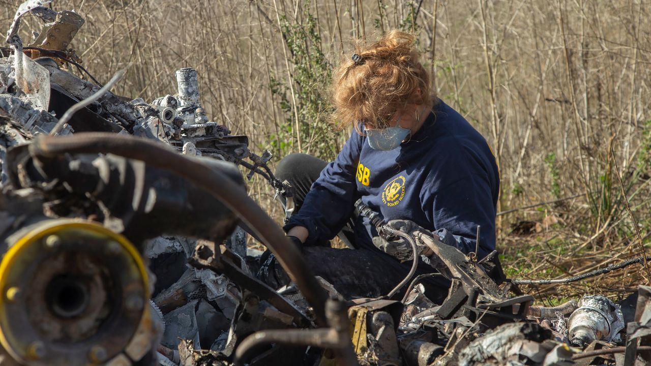 NTSB investigator Carol Horgan examines wreckage.